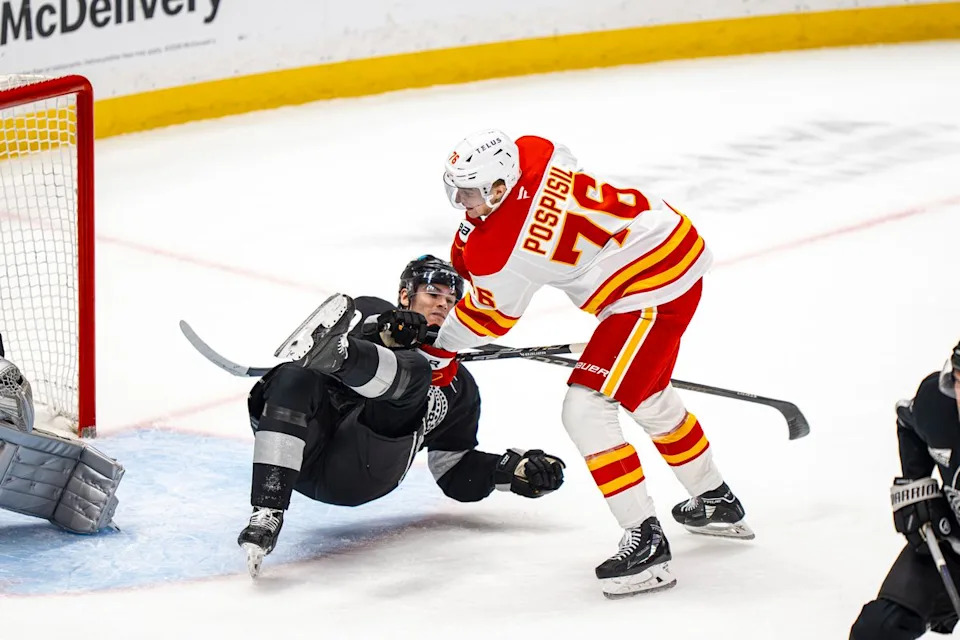 Calgary Flames center Martin Pospisil (76) dropping Kings' Jeff Malott during an NHL hockey game against the Los Angeles Kings on February 26th, 2026 in Los Angeles, CA.