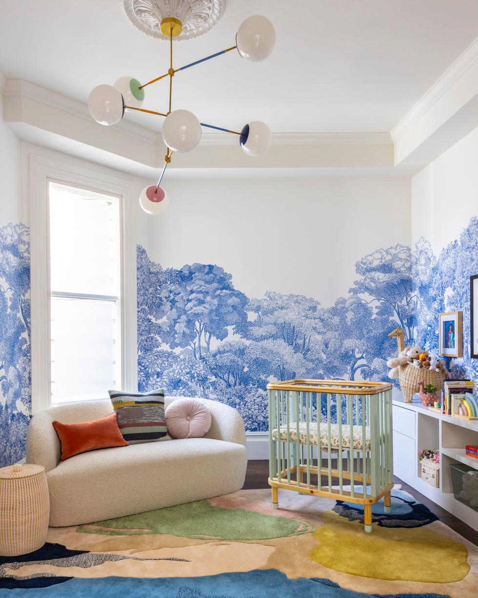 Modern nursery with a cozy seating area and crib.