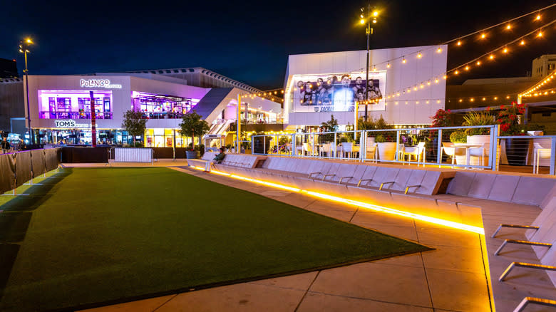Downtown Commons (DOCO)'s outdoor area glowing with string lights at night in Sacramento.