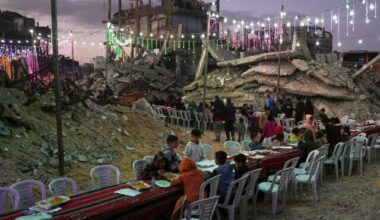 Palestinians sit at a long table amid the rubble of destroyed buildings as they gather for iftar, the fast-breaking meal, during the Muslim holy month of Ramadan in Khan Younis, Gaza Strip, Thursday, Feb. 19, 2026. (AP Photo/Abdel Kareem Hana)