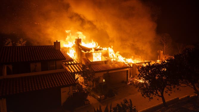 A home in the Highland neighborhood burns in the Palisades Fire, on January 8, 2025 in the Pacific Palisades community of Los Angeles, California.