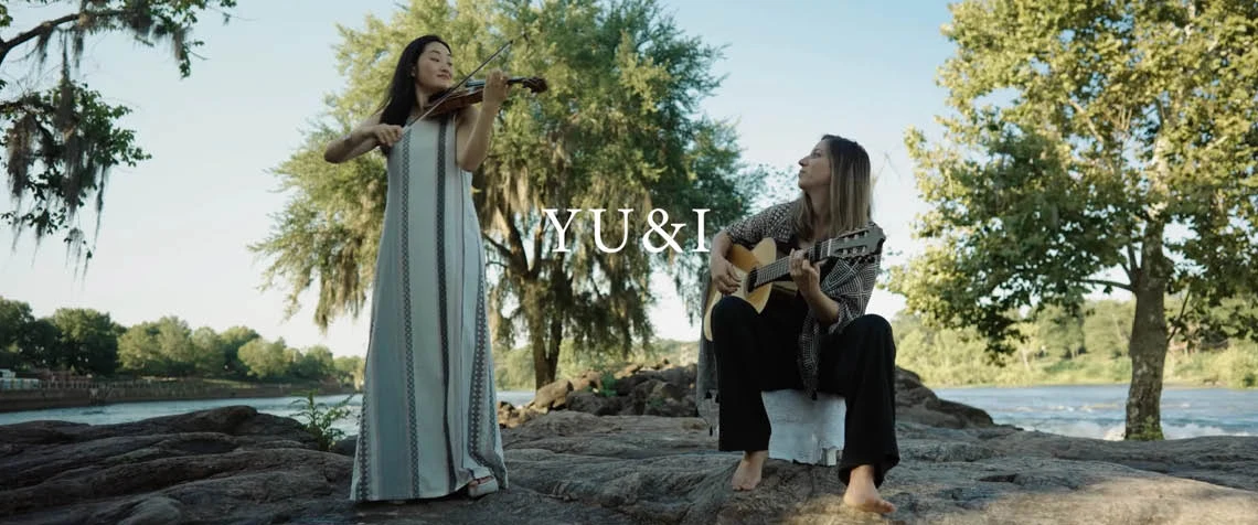 Guitarist and Violinist in front of trees