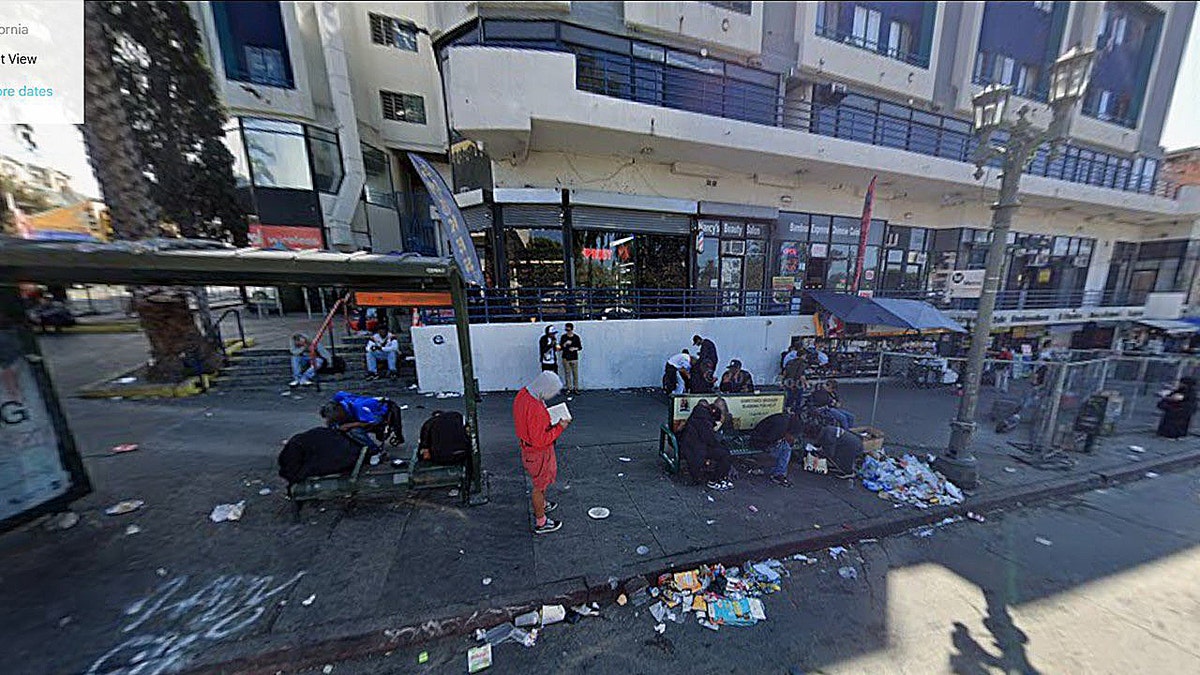 homeless people in littered area of city