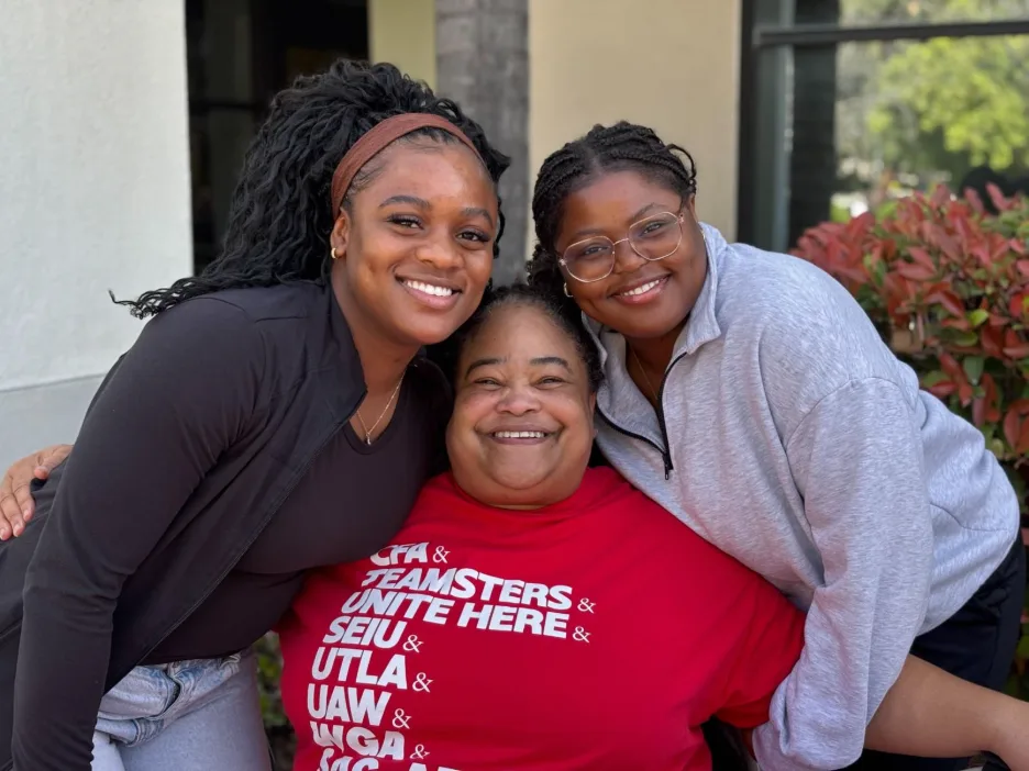 Three people pose for a photo