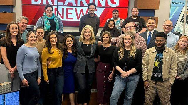 Michelle Bandur, center, stands with colleagues in the newsroom of KCRA in Sacramento in a recent photo. The on-air journalist has signed off after 35 years in TV news but will remain in Sacramento, she said.
