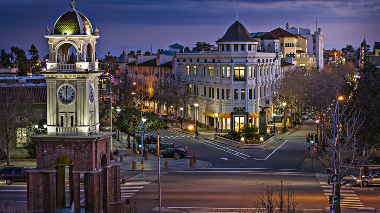 The town clock in Downtown Santa Cruz lights up at dusk.