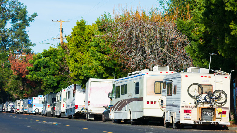 RVs lining a street in California under colorful trees