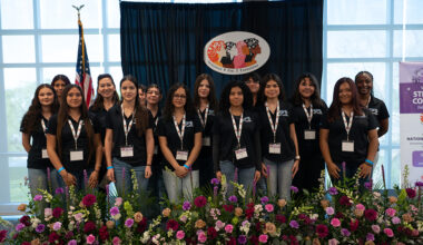 several attendees of the event posing together on event stage