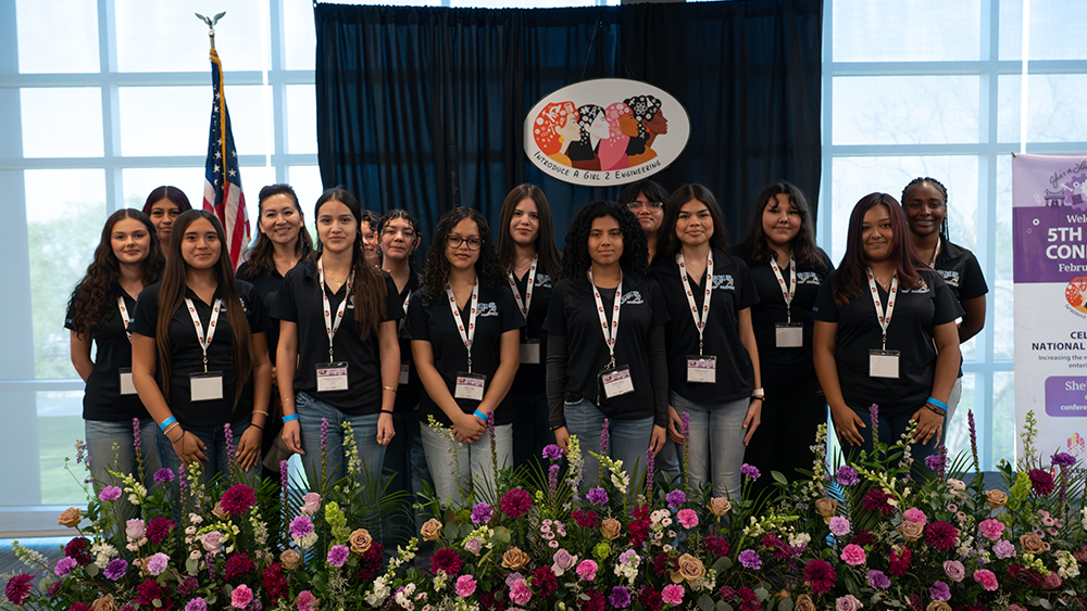 several attendees of the event posing together on event stage