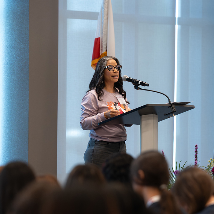 Event volunteer speaking to all attendees