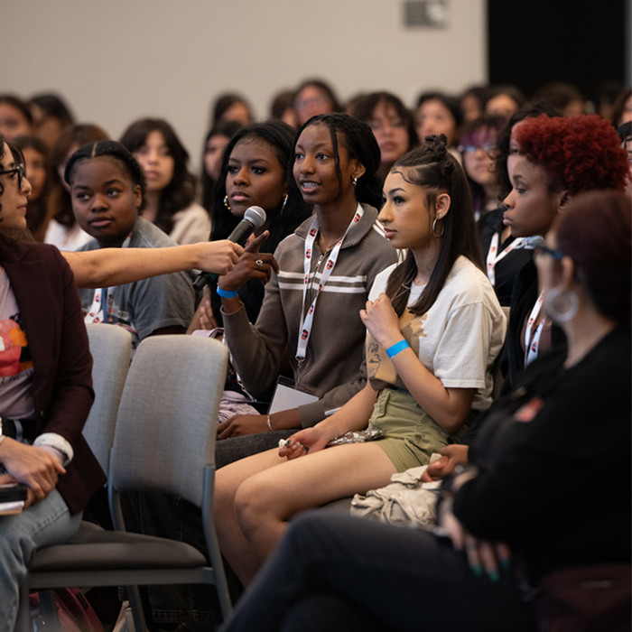 audience member asking a question into a microphone