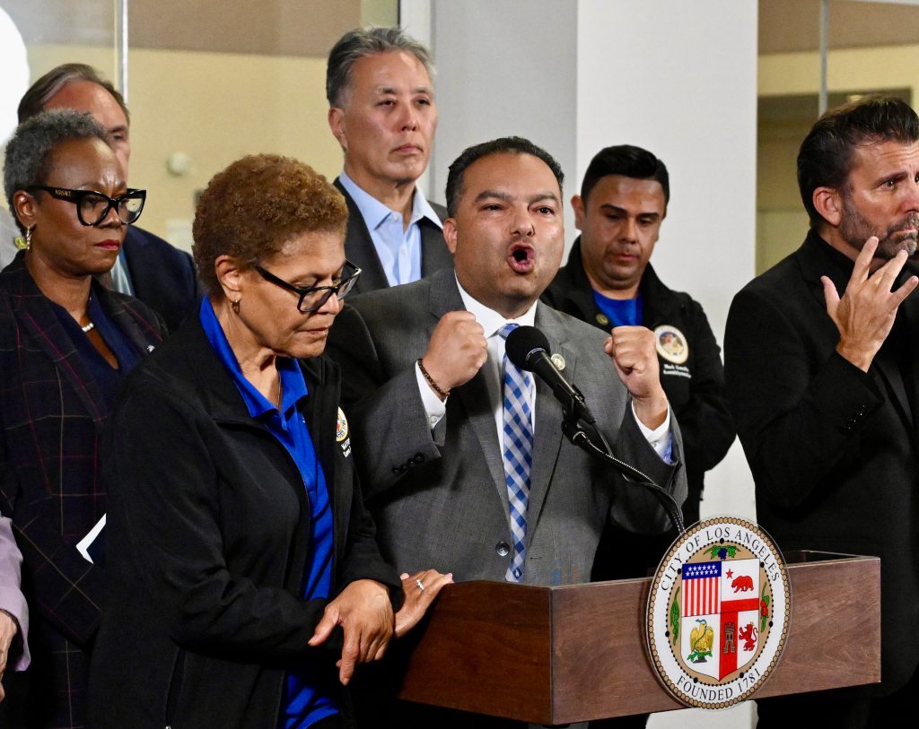 Jose Solache speaking at a press conference with Los Angeles Mayor Karen Bass to his left.