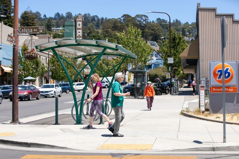 People walk on a sidewalk along Solano Avenue in Berkeley