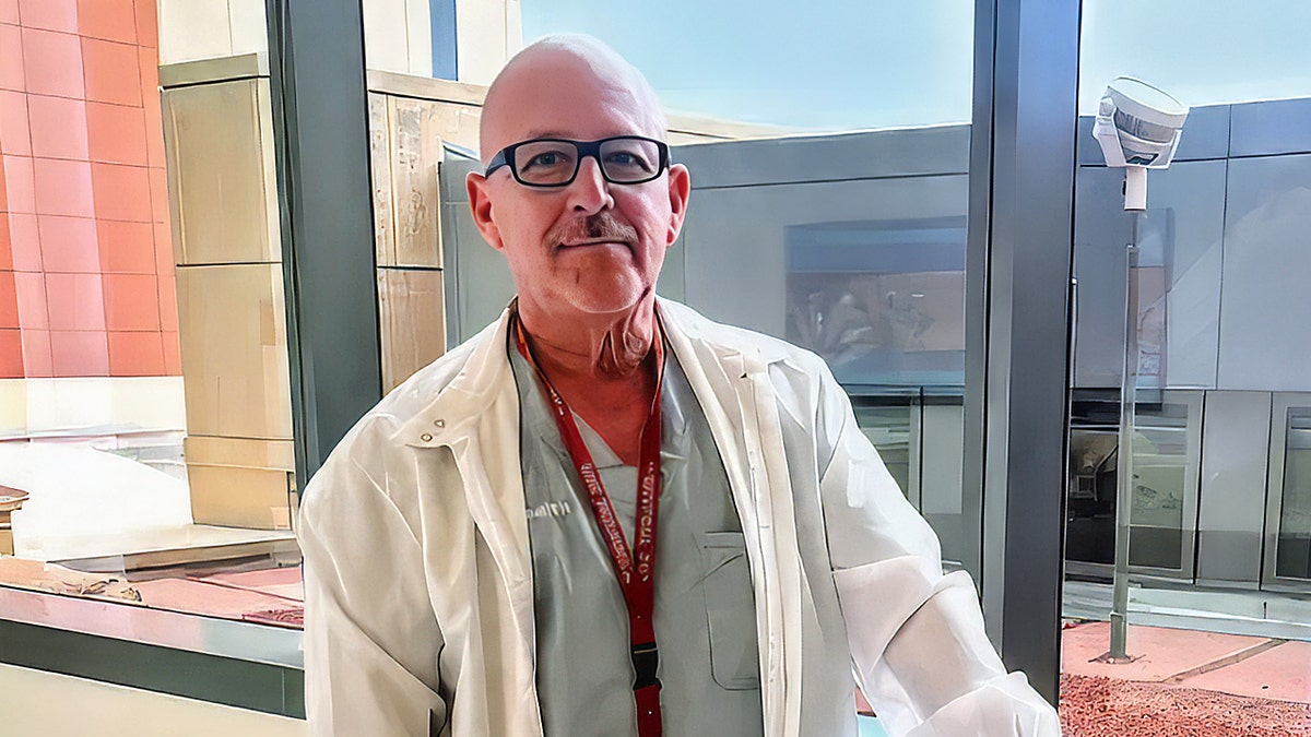 Reinaldo Lefonts wearing a lab coat