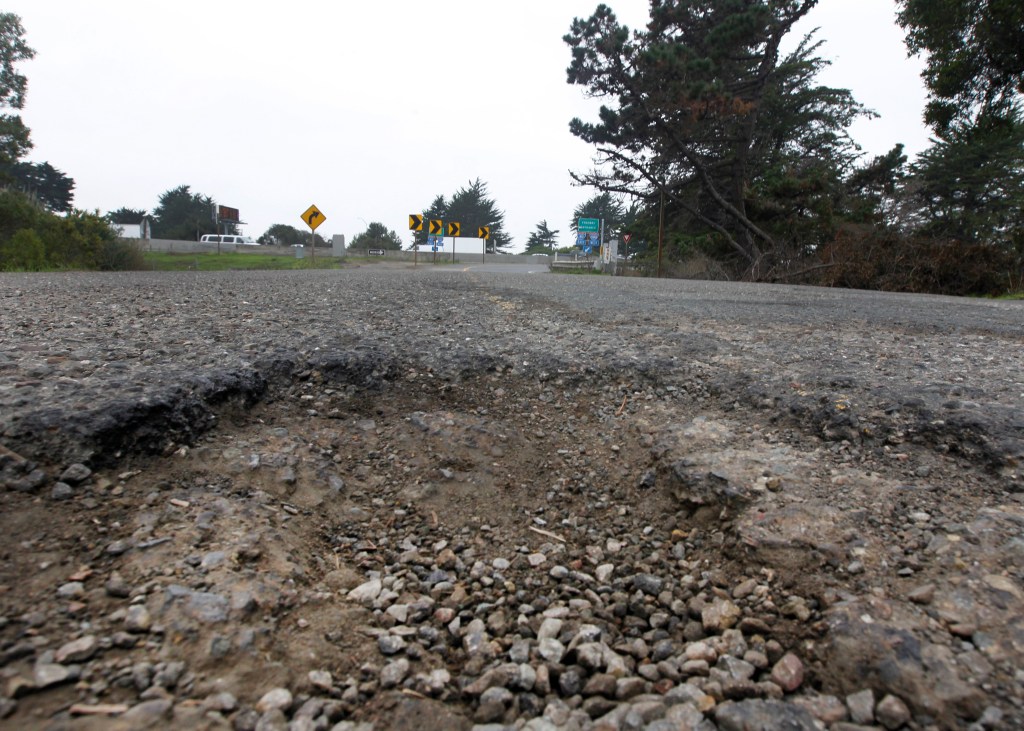 Deep potholes on a street leading to the I-80 on-ramp.
