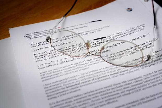 Frustrated that the system doesn't work, June Dudas maintains a detailed binder full of handwritten notes, letters, and printouts of emails she has sent to numerous offices and agencies regarding her cousin, Ed, and the physical threat he poses to his mother, June's aunt. (Nelvin C. Cepeda / The San Diego Union-Tribune)