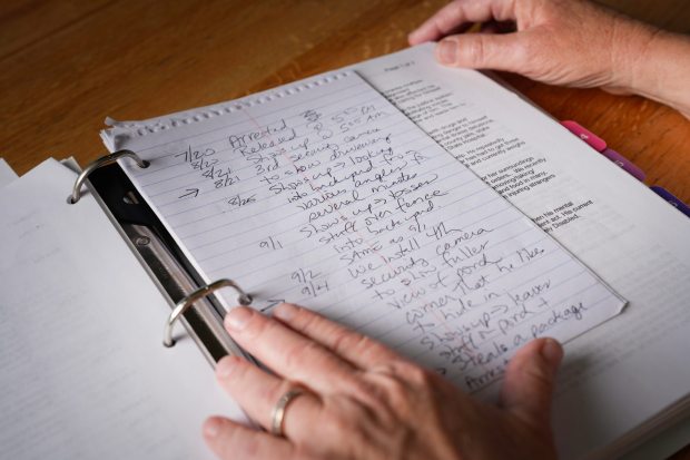 El Cajon, CA - March 20: Frustrated that the system doesn't work, June Dudas maintains a detailed binder full of handwritten notes, letters, and printouts of emails she has sent to numerous offices and agencies regarding her cousin, Ed, and the physical threat he poses to his mother, June's aunt. (Nelvin C. Cepeda / The San Diego Union-Tribune)