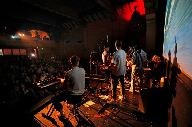 The La Jolla-based band Sea Poodle plays their original score live in concert to the surf film Confluence to a sold out crowd at the La Paloma Theatre in Encinitas on Sunday, Dec. 8, 2024. (K.C. Alfred / The San Diego Union-Tribune)