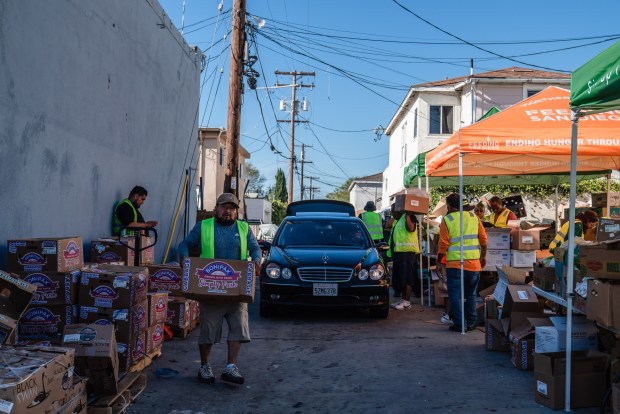 Cars wait in line at a food distribution with food from Feeding San Diego at  Iglesia Casa de Alabanza in City Heights  on March 26, 2026. (Ariana Drehsler / For The San Diego Union-Tribune)
