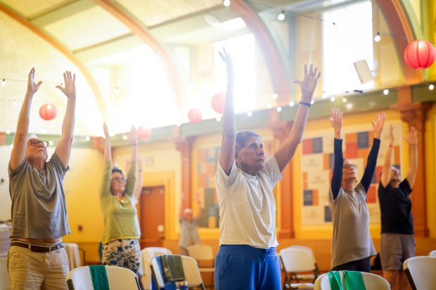 Maggie Jacobs, center, reaches up during a seniors' exercise class at the LGBT Community Center on Friday, Feb. 27, 2026 in San Diego, California. (Meg McLaughlin / The San Diego Union-Tribune)