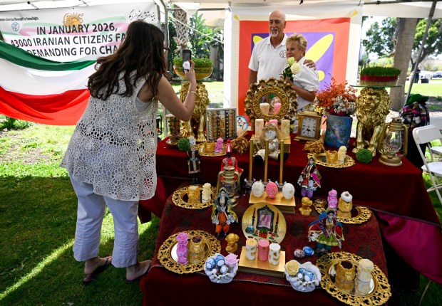 Iranians pose with a haft seen at a celebration of Nowruz, the Persian New Year, on March 15, 2026, at Balboa Park in San Diego. (Denis Poroy / For The San Diego Union-Tribune)