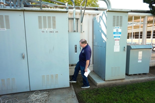 On Thursday, March 12, 2026, Cajon Valley Union School District's facilities director Johnny Heredia points out how the electrical box where the main feed comes into Chase Avenue Elementary School needs to be replaced.  (Nelvin C. Cepeda / The San Diego Union-Tribune)
