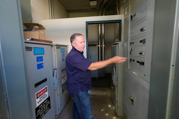 Cajon Valley's facilities director Johnny Heredia points out the outdated main electrical power box that feeds Greenfield Middle School in El Cajon on March 12, 2026.  (Nelvin C. Cepeda / The San Diego Union-Tribune)