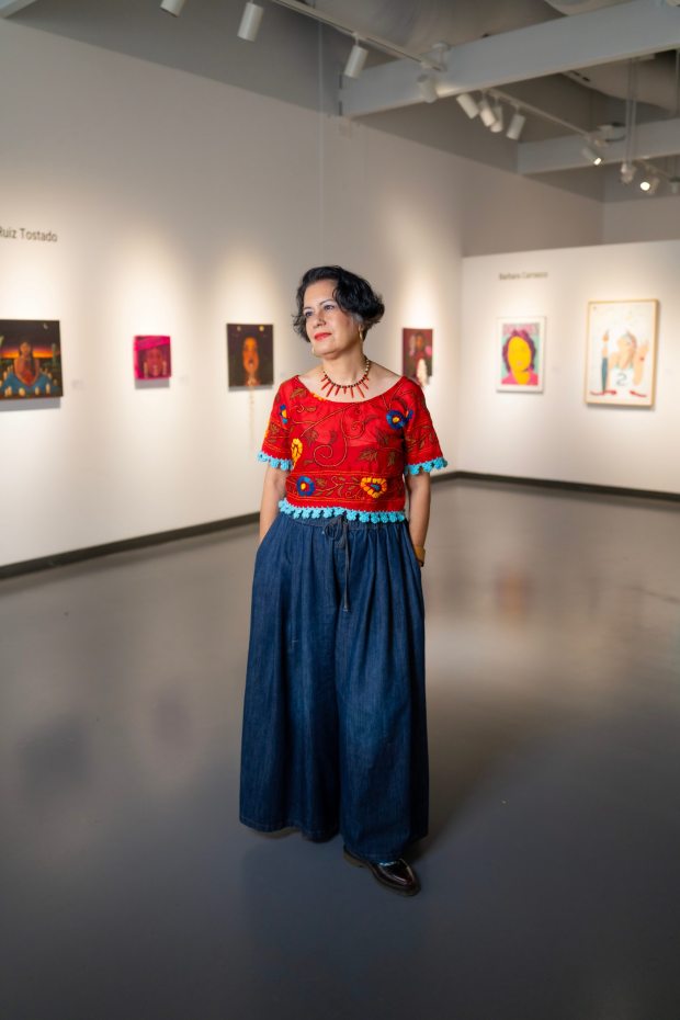 Standing in the campus Art Gallery at Mesa College, Alessandra Moctezuma is the gallery director and a professor of art at San Diego Mesa College, where she runs the Museum Studies program. Alessandra was born in Mexico City and immigrated to Los Angeles with her family in 1981. (Nelvin C. Cepeda / The San Diego Union-Tribune)