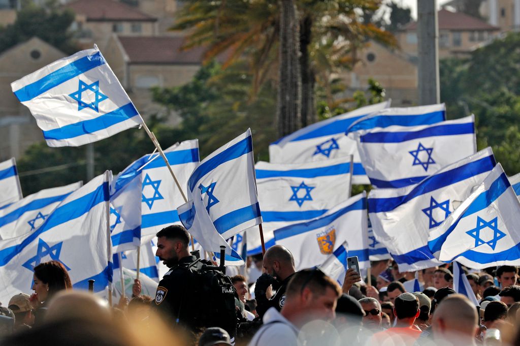 People marching with Israeli flags.