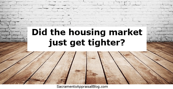 white bricks in the background on a wall and a brown wooden floor. There is white rectangle in the middle of the image with black font asking, "Did the housing market just get tighter?"
