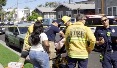 Long Beach toddler killed when car speeds backward over curb; man held