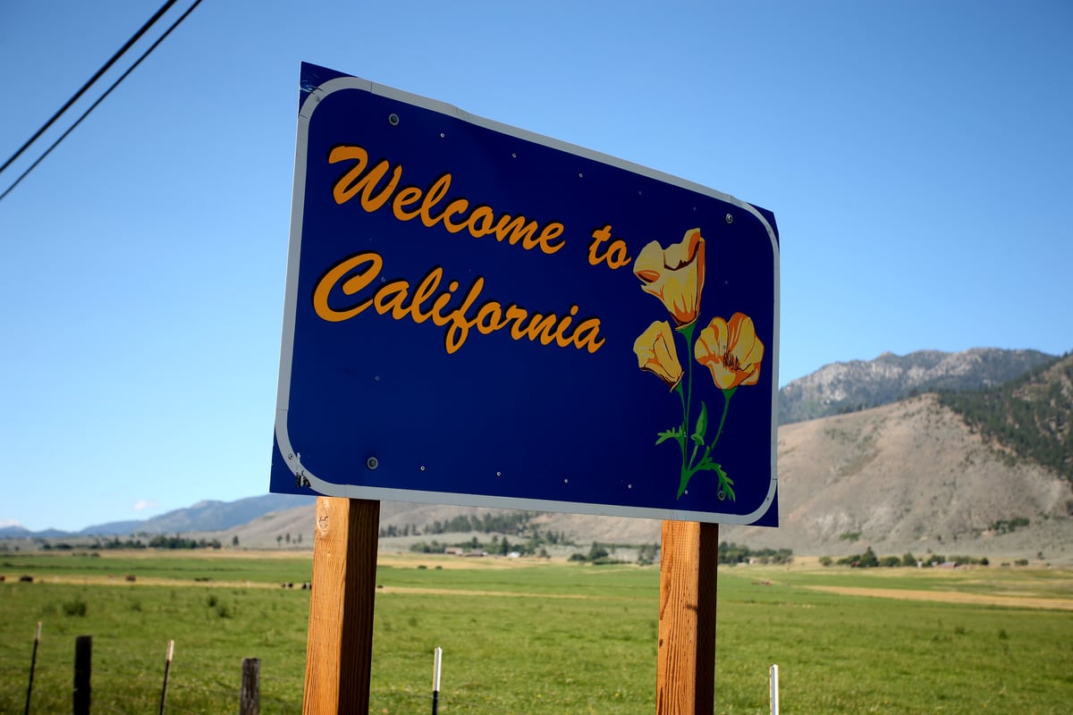 A road sign says welcome to California.