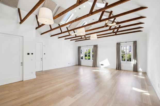 Open concept living room with exposed beams.