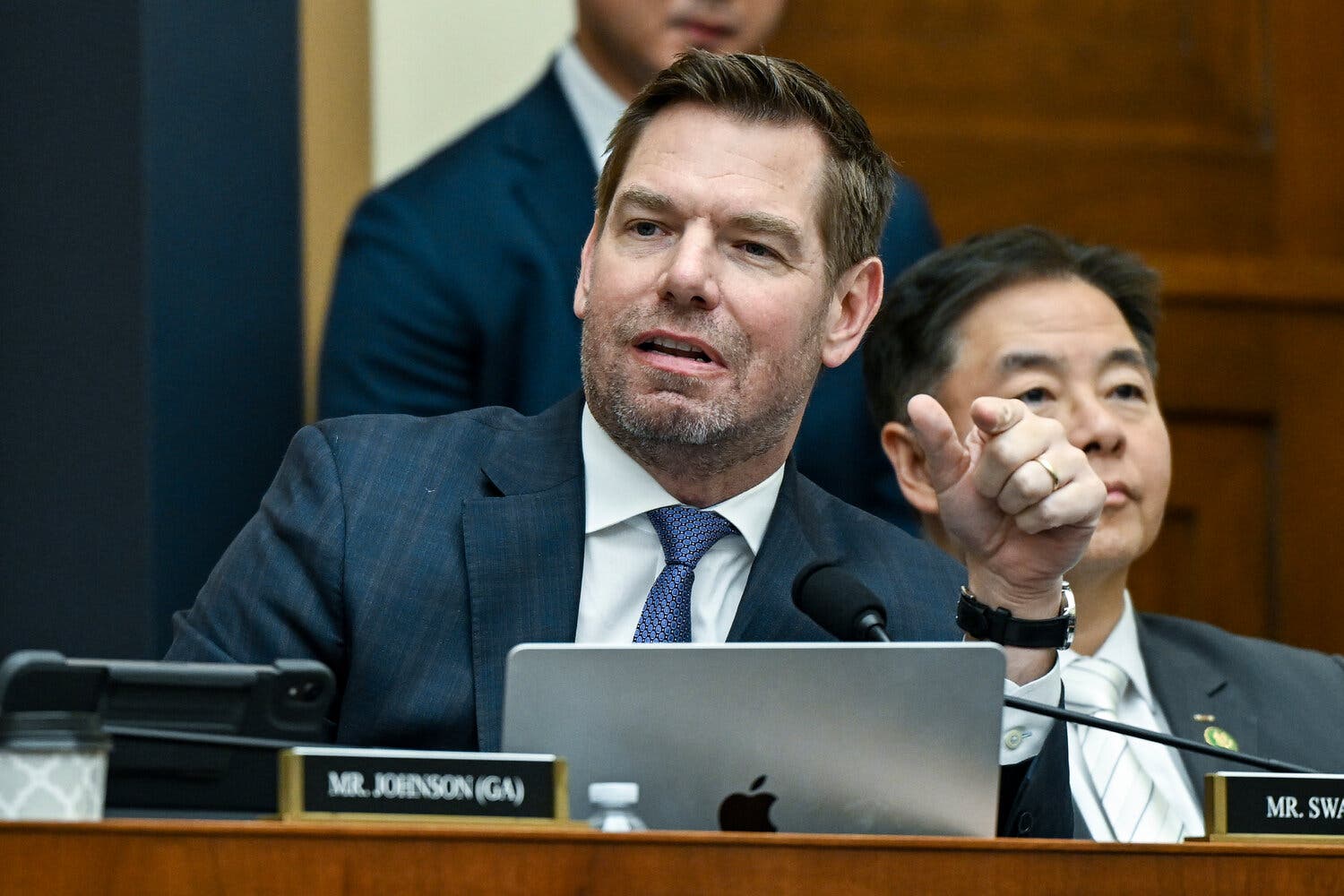 Eric Swalwell sitting at a desk during a House hearing and speaking.