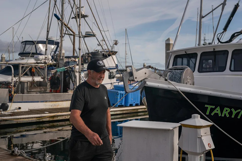 Fisherman Chris Pedersen walks on a dock in Half Moon Bay in 2024.