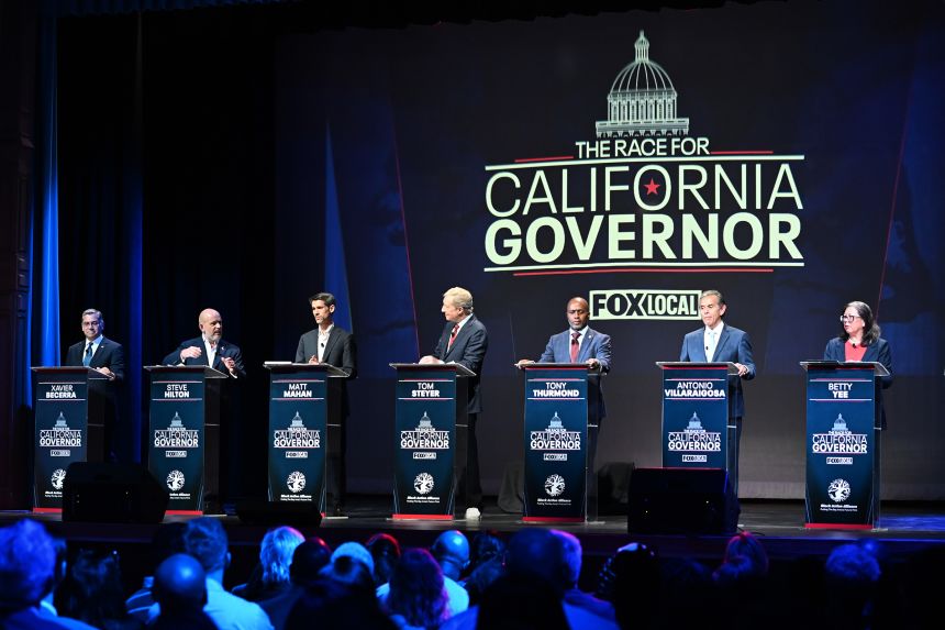 From left: Xavier Becerra, Steve Hilton, Matt Mahan, Tom Steyer, Tony Thurmond, Antonio Villaraigosa and Betty Yee stand on the stage during the California gubernatorial candidate debate in San Francisco, on Febrary 3.