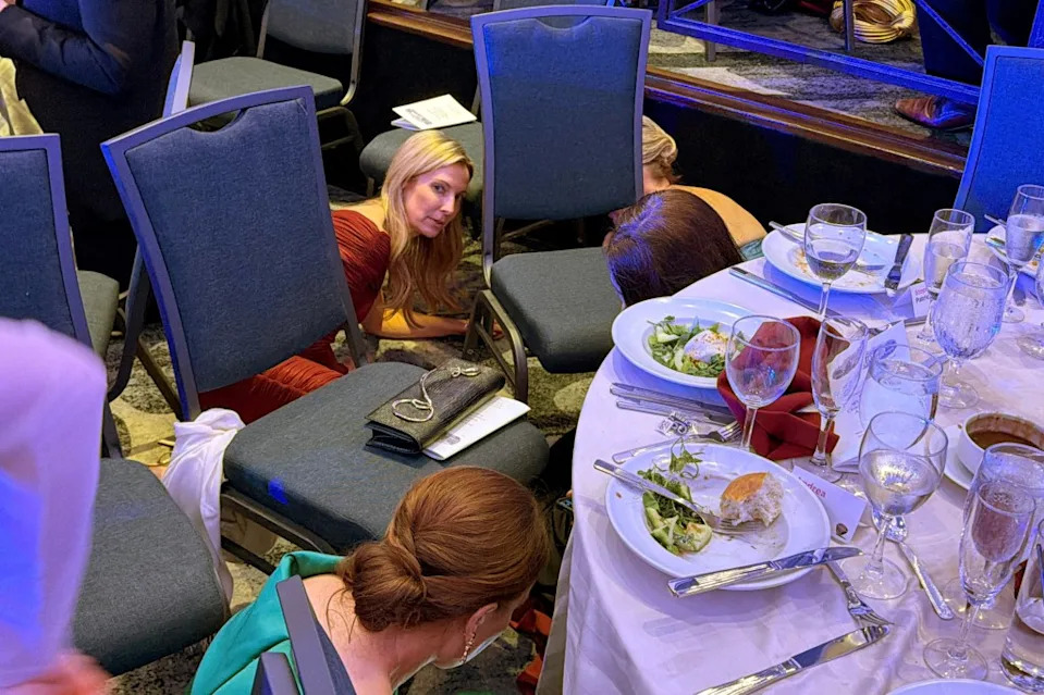 Guests take cover under tables after shots rang out outside the ballroom of the Washington Hilton hotel on April 25, 2026. REUTERS