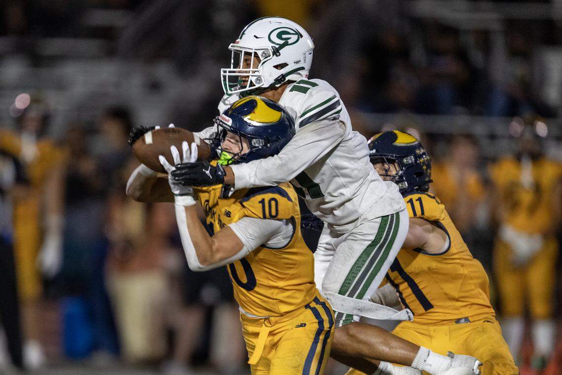 The Oak Ridge Trojans' Jasen Womack (10) intercepts a pass intended for the Granite Bay Grizzlies' Izaiah Galovich (11) on Sept. 26 in El Dorado Hills.