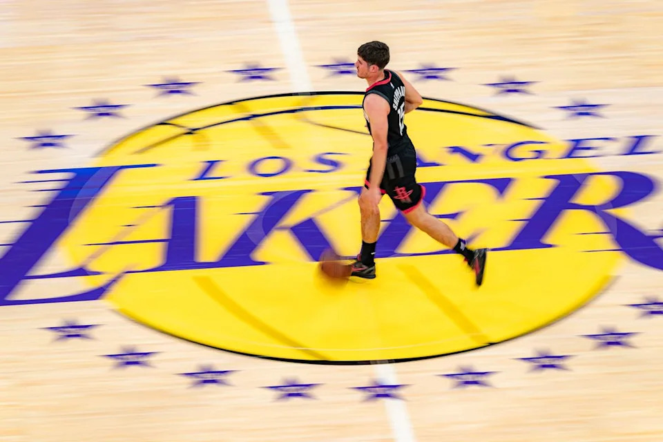 Houston Rockets guard Reed Sheppard (15) dribbling over the center court logo during an NBA basketball game against the Los Angeles Lakers on April 18th, 2026 in Los Angeles, CA.