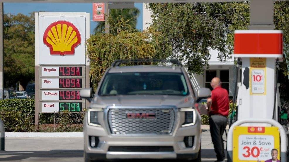 FILE - Fuel prices are displayed on a sign as a customer fills their vehicle at a gas station on April 13, 2026, in Miami. (Photo by Joe Raedle/Getty Images)
