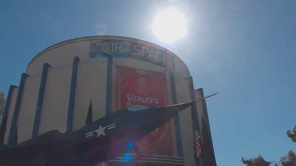 Sunlight shines over the San Diego Air and Space Museum as visitors gather ahead of the Artemis II splashdown.