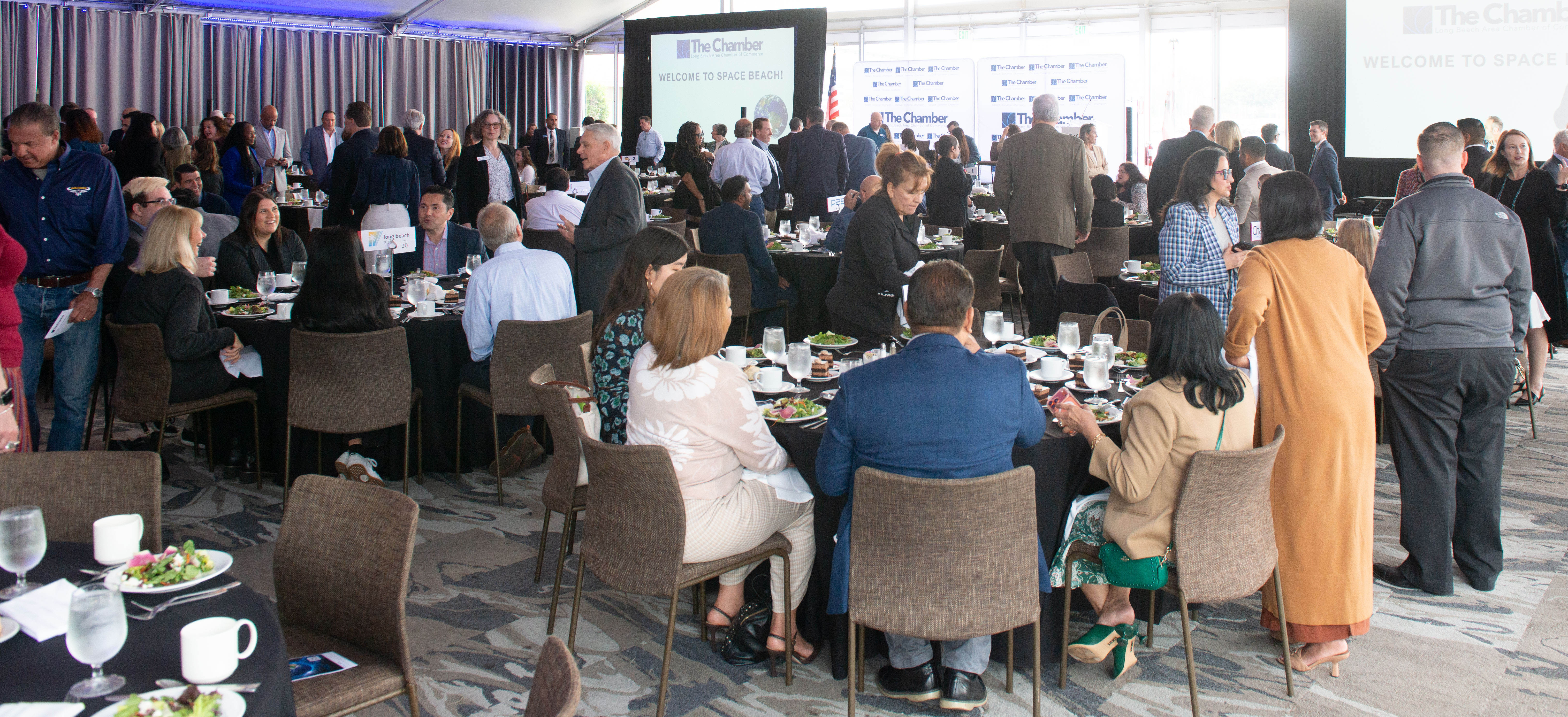 Attendees of the fourth annual Space Beach Luncheon gather before...