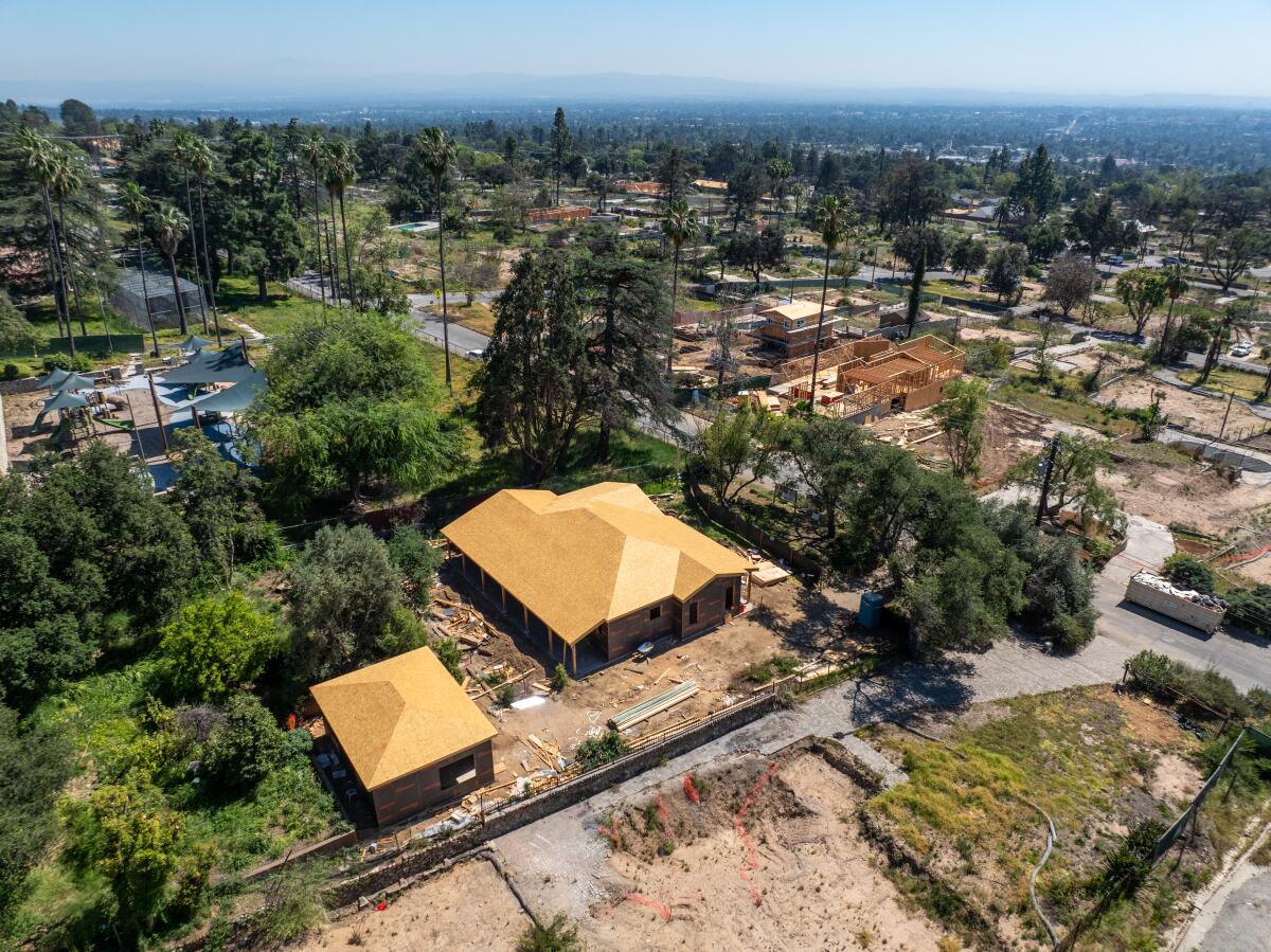 An aerial view of construction crews rebuilding homes