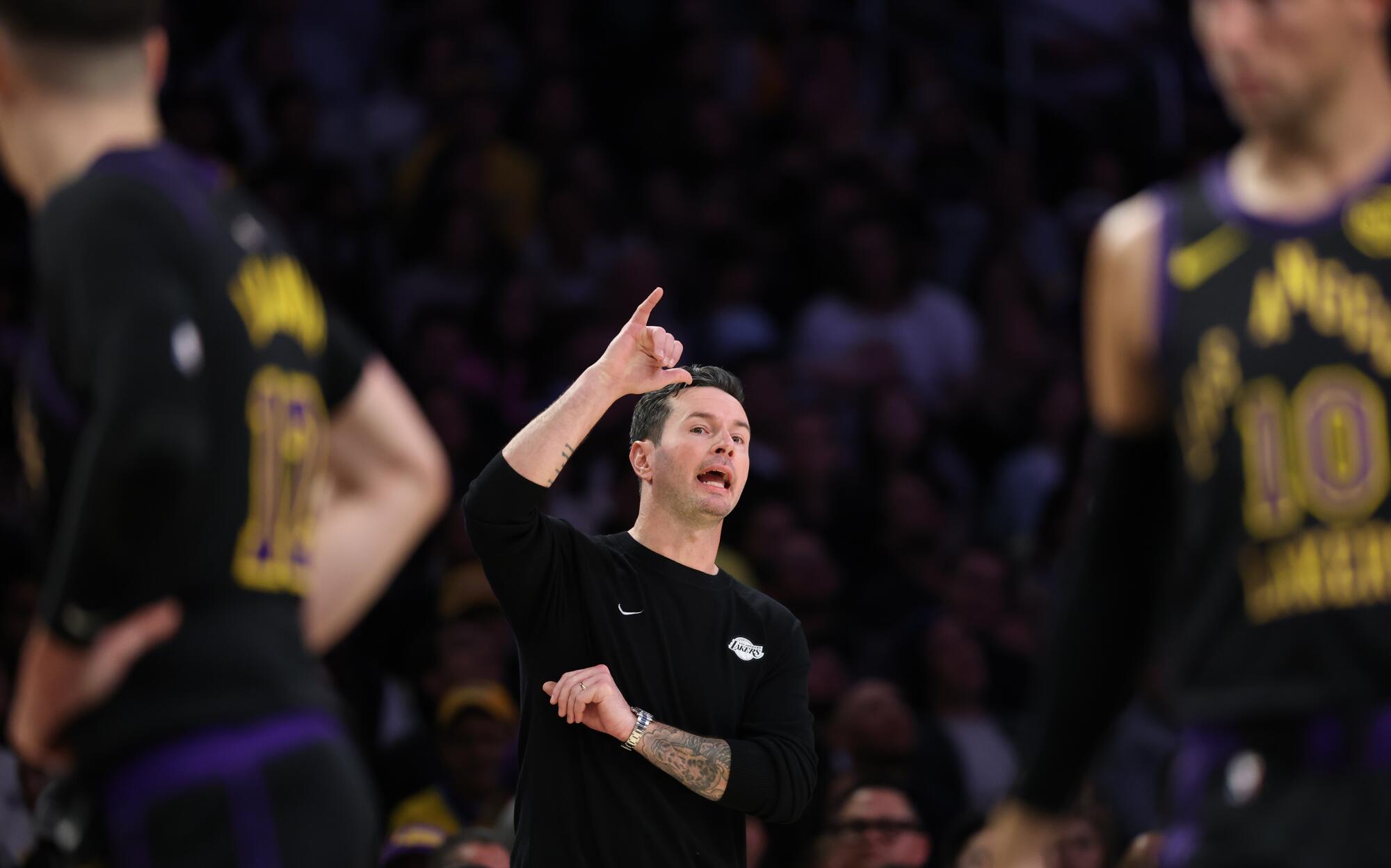 Lakers coach JJ Redick directs players during a win over the Cavaliers at Crypto.com Arena on Tuesday.