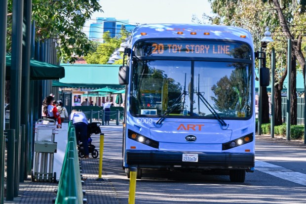 Bus riders take Anaheim Regional Transportation (ART) buses shuttles from the Toy Story parking lot to the Disneyland Resort on Thursday, January 29, 2026, in Anaheim, CA. The Anaheim Transportation Network's board voted Wed. Jan. 28 to "wind down" operations, with the last day of shuttling planned for March 31. The bus system moves 8 million riders a year around the resort area. (Photo by Jeff Gritchen, Orange County Register/SCNG)