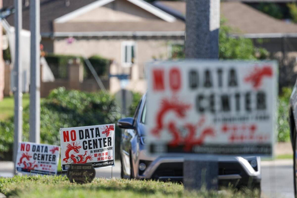 Signs of protest pepper frontyards in a neighborhood in Monterey Park.