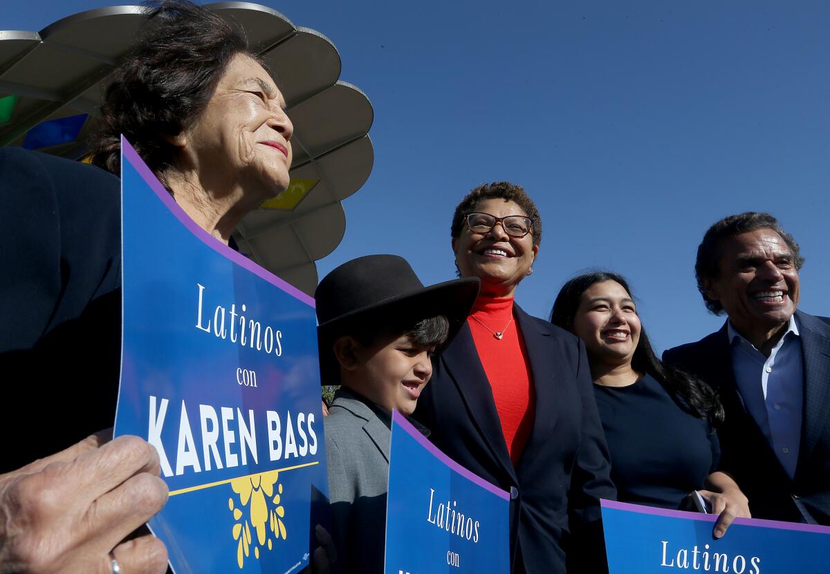 Five adults and children stand in a row.