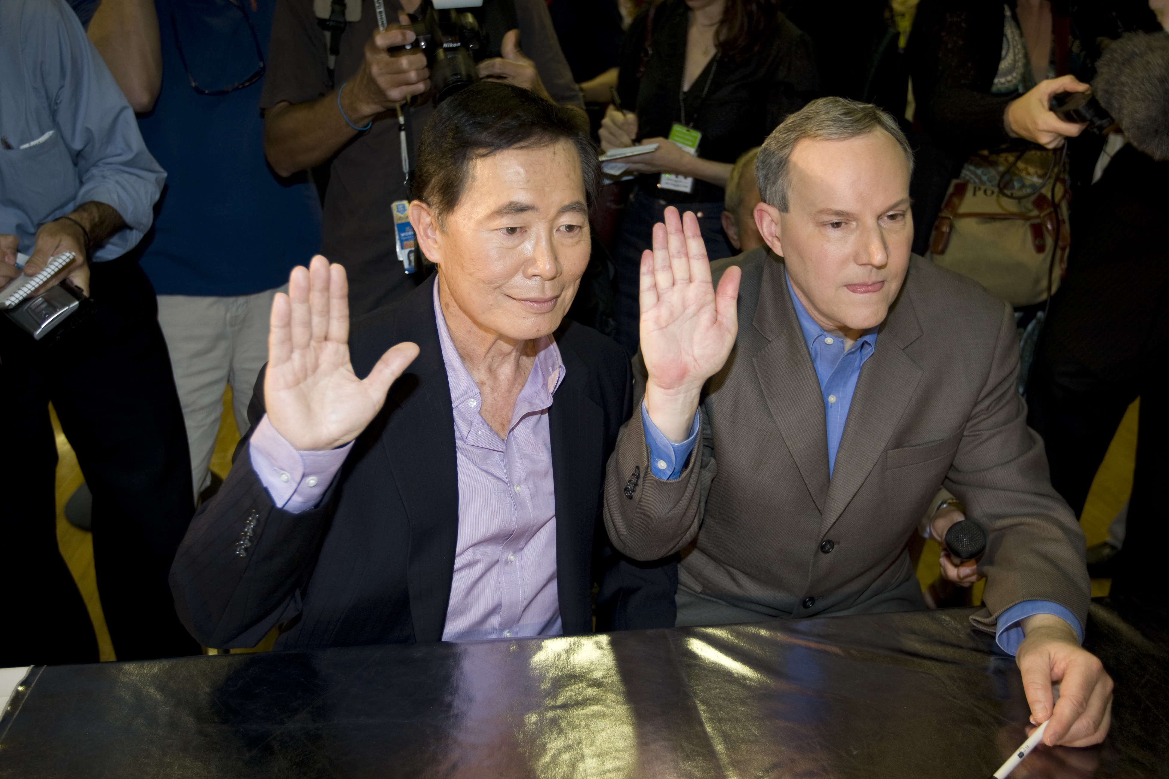 George Takei, left, and his partner Brad Altman raise their...