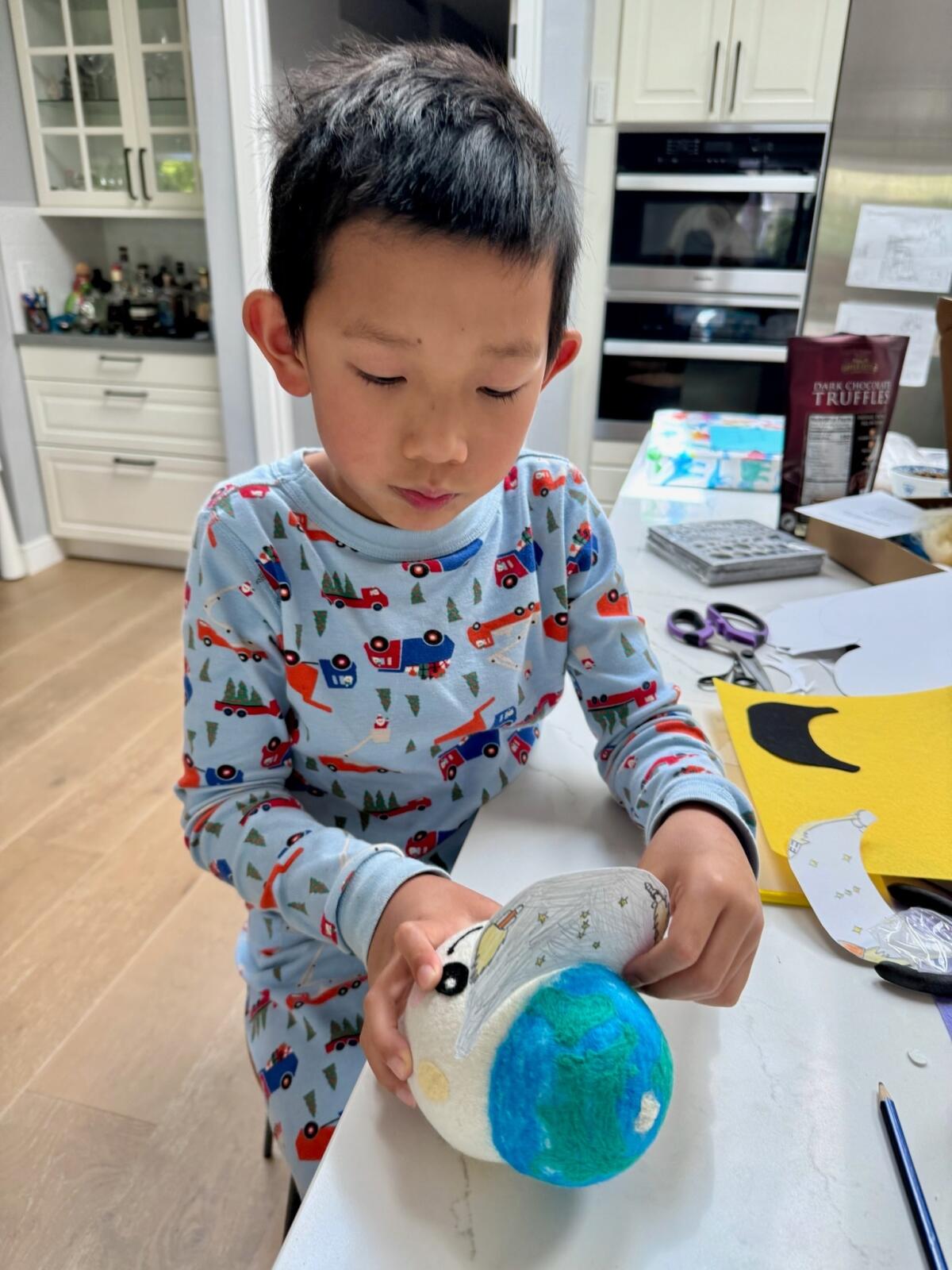 A child holding onto a ball shaped object.