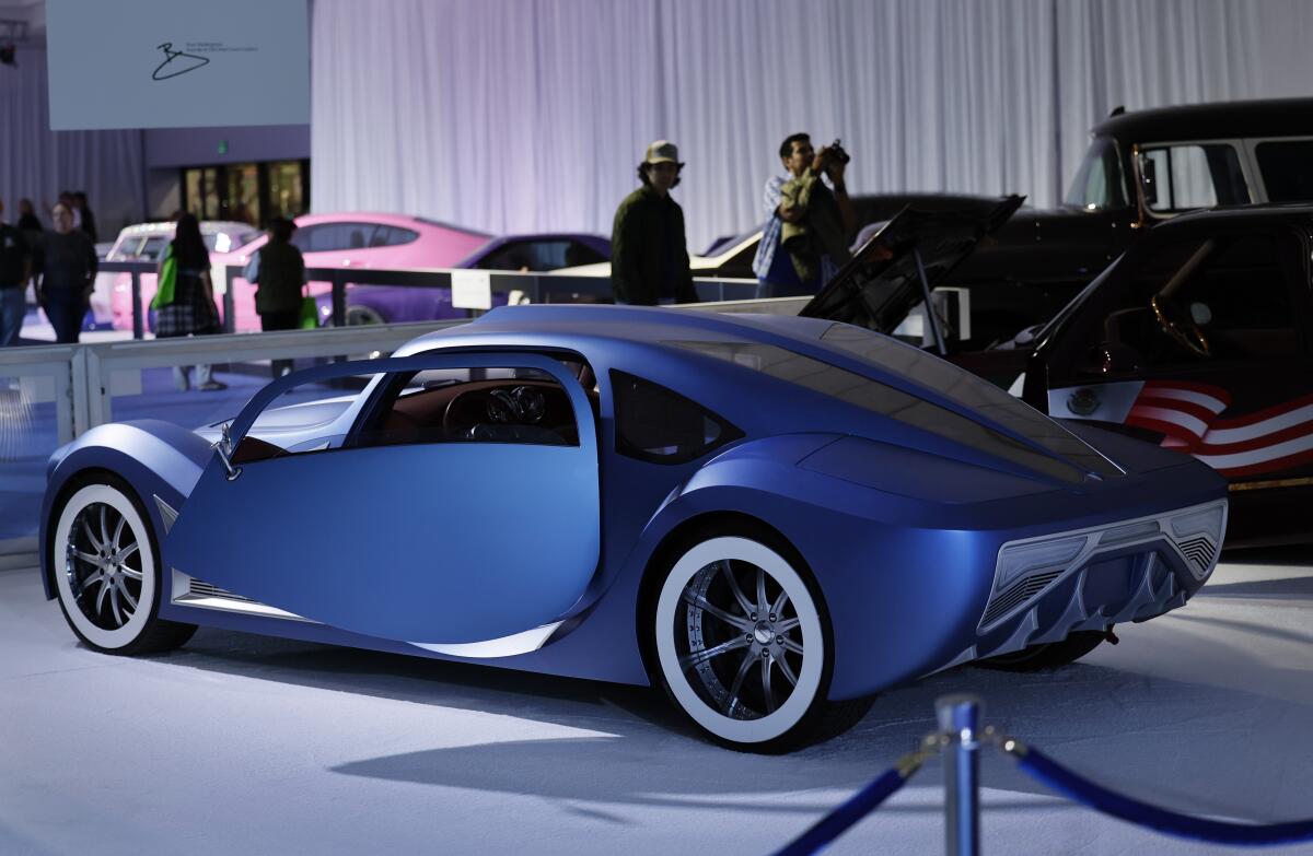 Auto enthusiasts check out West Coast Customs cars on display.